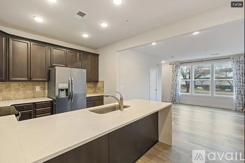 A kitchen with brown cabinets and a white countertop is available for rent.