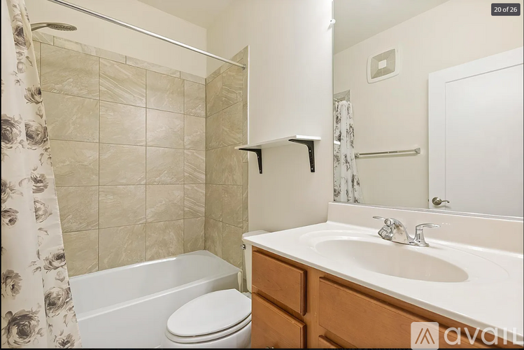 A bathroom with a toilet, sink, and shower.