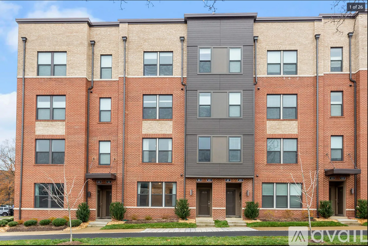 A row of townhouses with a mix of brick and siding exteriors.