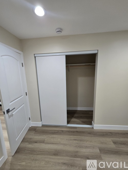 A room with a white door and a white wall.