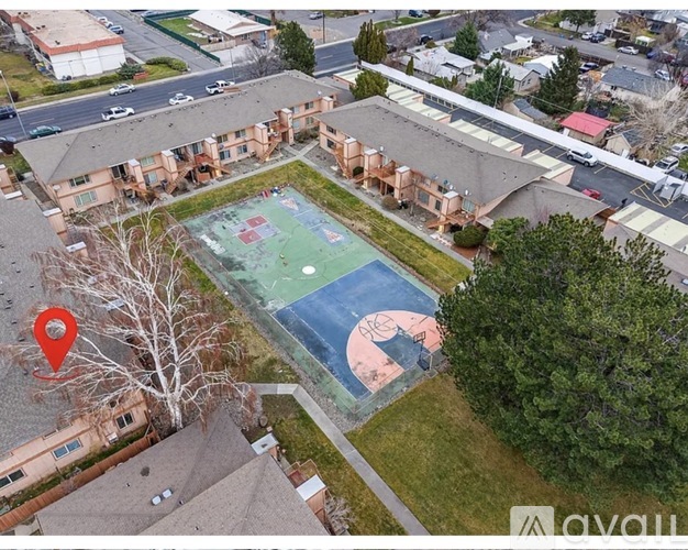 An aerial view of a basketball court surrounded by buildings.