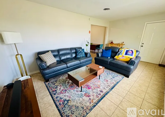 A living room with a blue couch and a coffee table.