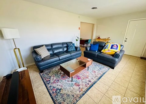 A living room with a blue couch and a coffee table.