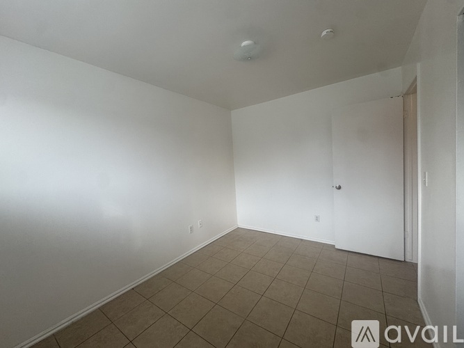 A room with white walls and a tiled floor.