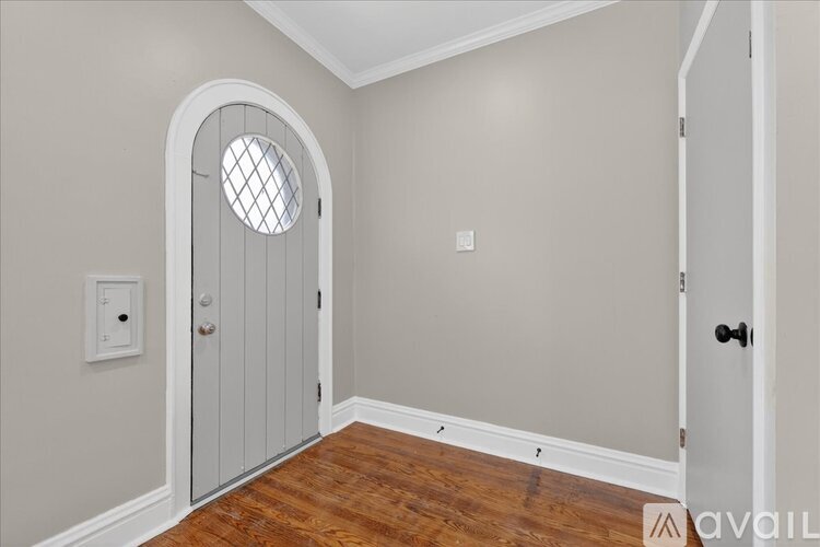 A dining room with a table set for six and a ceiling fan.