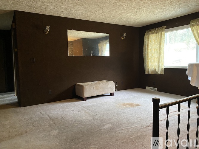 A bedroom with a bed, dresser, and mirror.