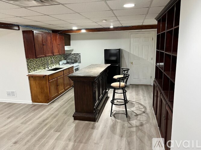 A kitchen with a bar stool and a counter.