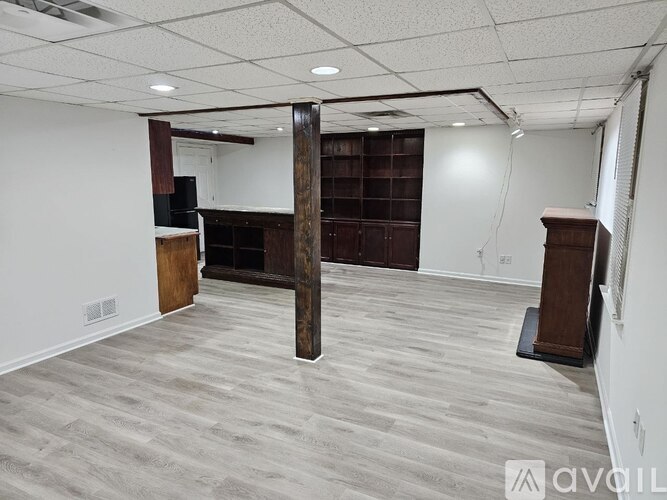 A room with a wooden bookcase and a speaker.