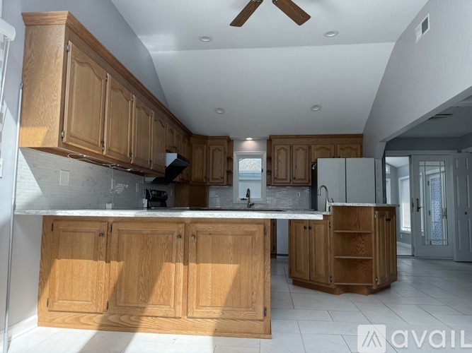 A kitchen with wooden cabinets and a white countertop.