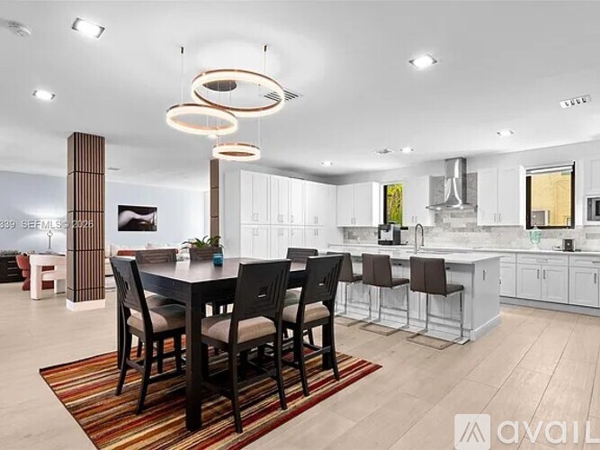 A modern kitchen with a dining table set for four.
