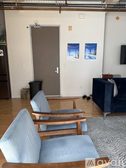 A room with a blue chair and a brown table.