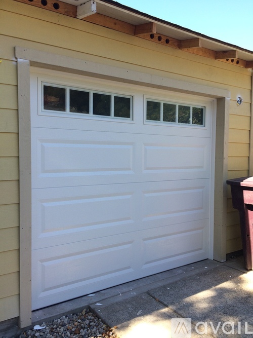 A white garage door with a window on the top.