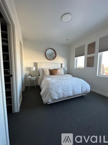 A bedroom with a large bed and a mirror on the wall.
