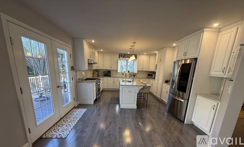 A spacious kitchen with white cabinets and a center island.