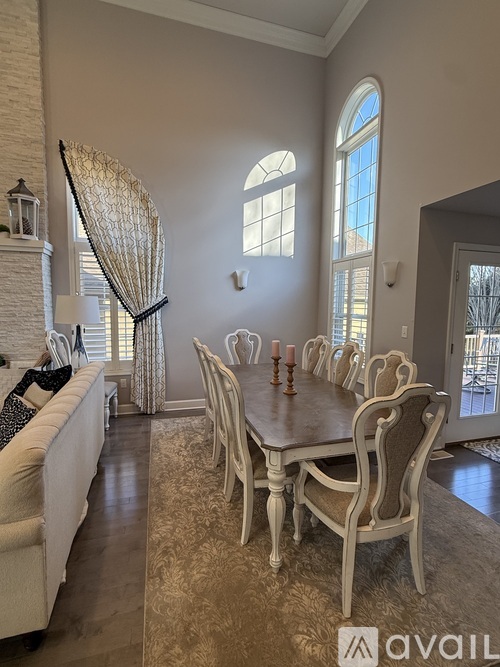 A dining room with a long table and chairs.
