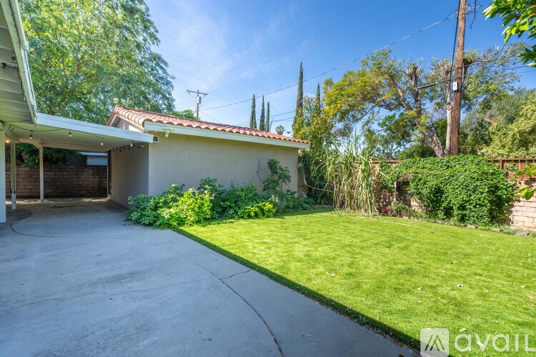 A house with a driveway and green grass.
