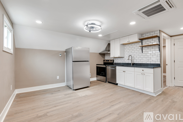 A kitchen with a refrigerator, stove, and sink.
