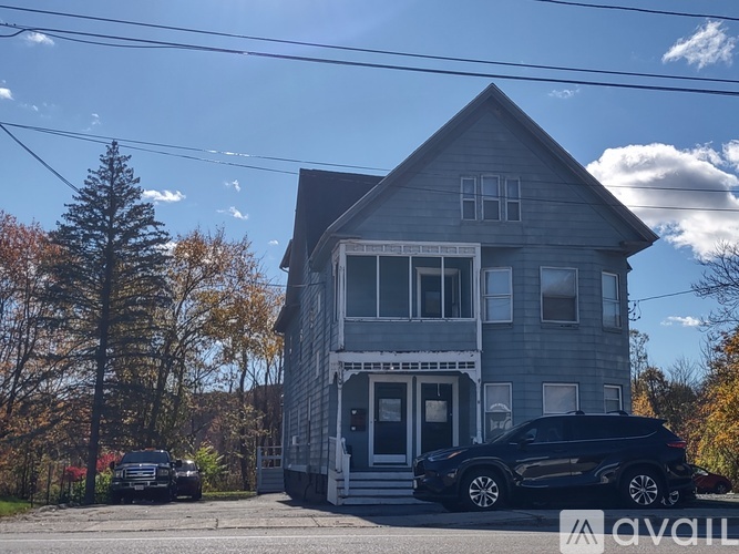 A house with a car parked in front of it.