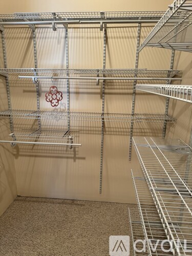 A metal shelving unit with a flower design on the wall.