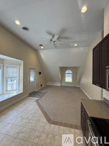 A room with a ceiling fan and a window.