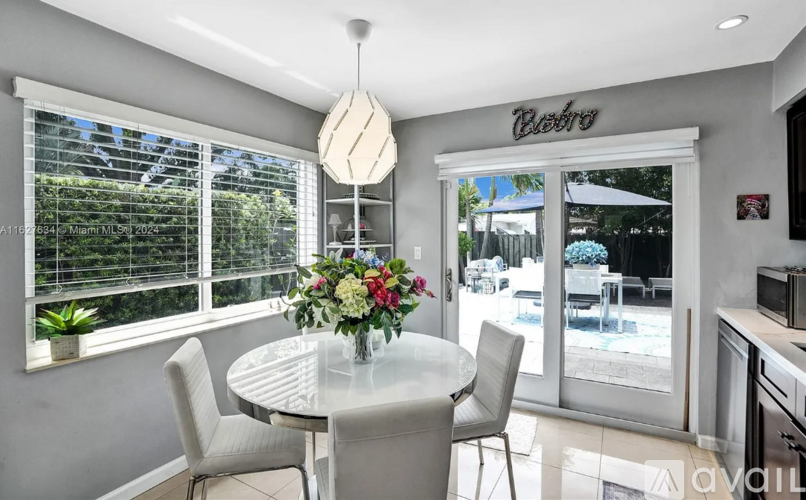 A dining room with a table set for four.