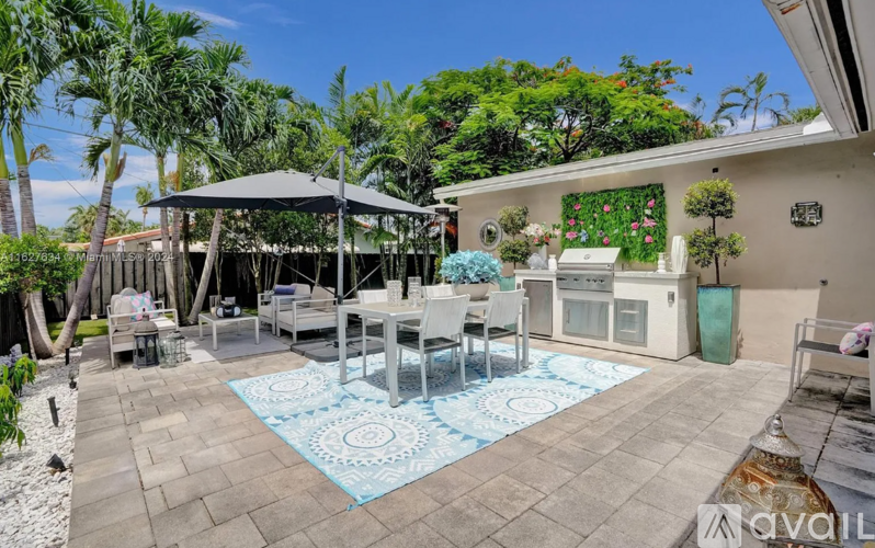 A patio with a table set for dining and a pool table.