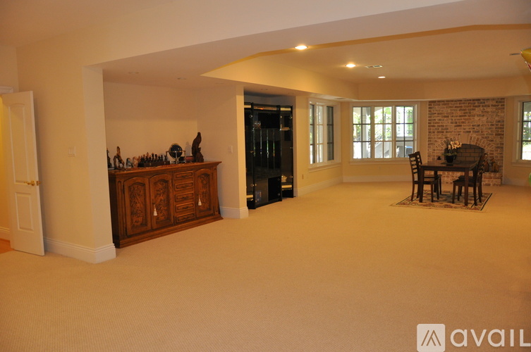 A living room with a dining table and chairs.