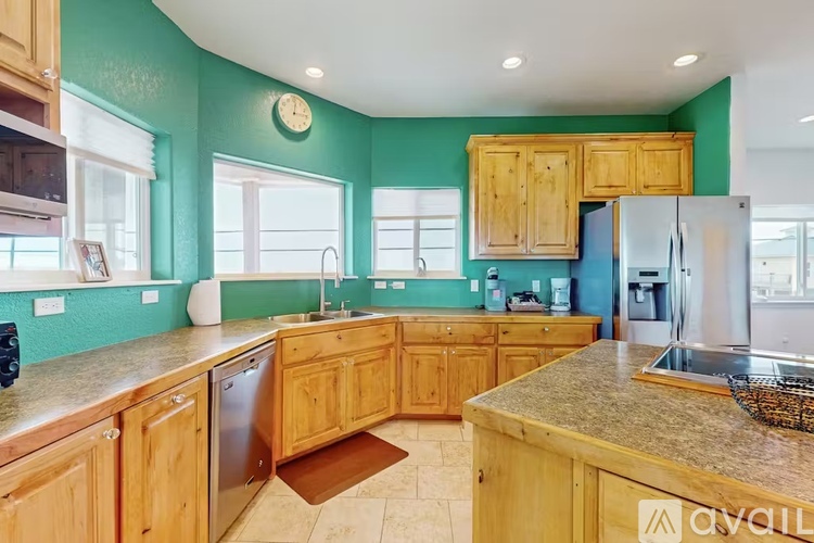 A kitchen with wooden cabinets and a granite countertop.