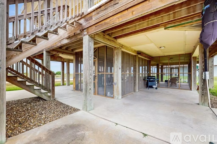 A wooden staircase leads to a large open space with glass walls.