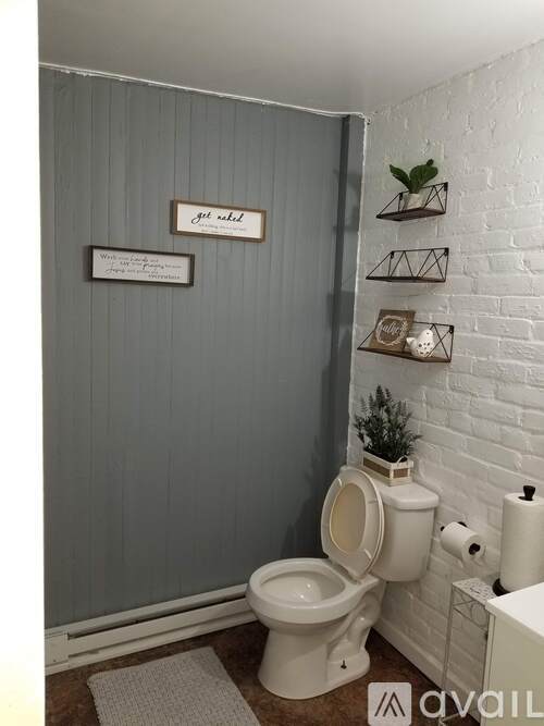 A bathroom with a toilet and a sign on the wall.
