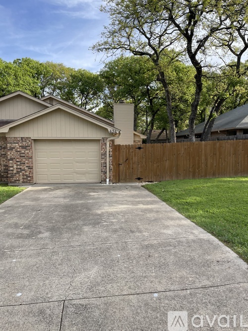 A house with a garage and a driveway in front.