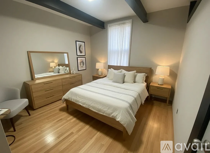 A bedroom with a large bed, a dresser, and a mirror.