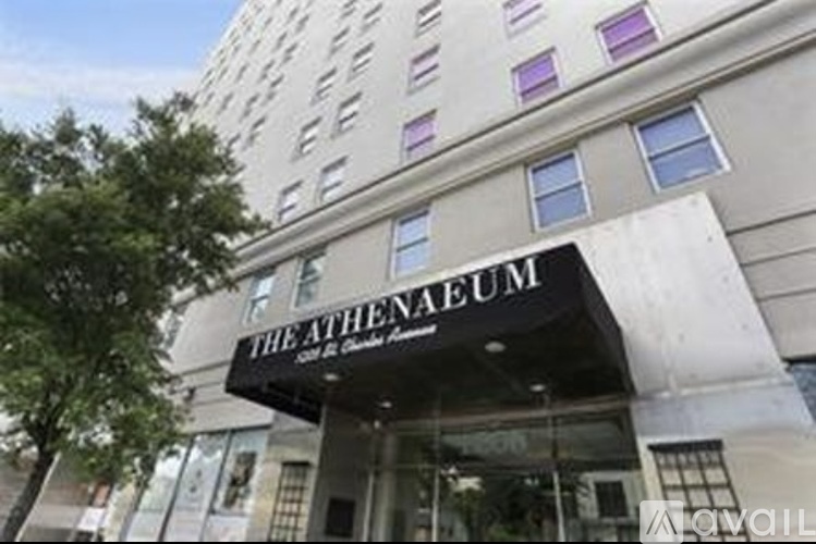 The Athenaeum is a building with a black awning and white walls.