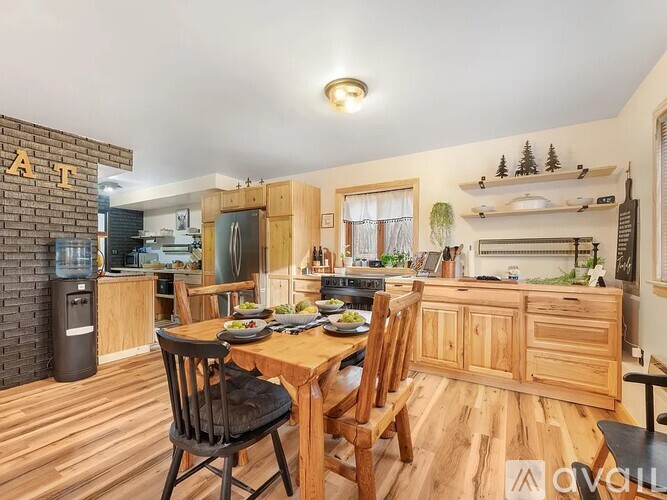 A kitchen with a dining table and chairs.