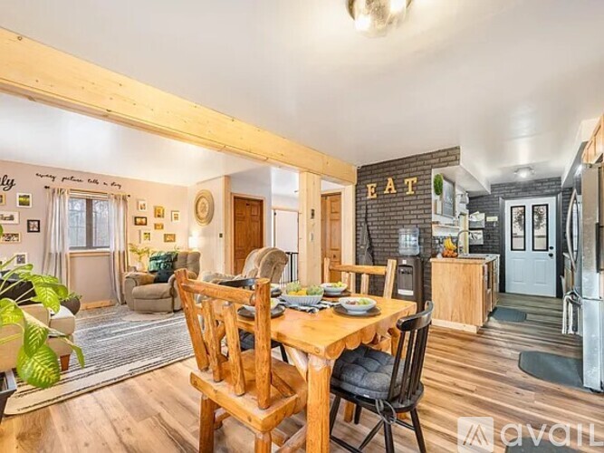 A dining room with a wooden table and chairs.