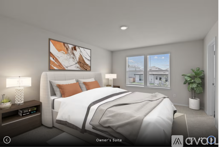 A bedroom with a large bed and a painting on the wall.