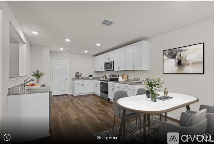 A modern kitchen with a dining table and chairs.
