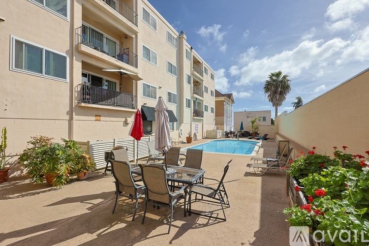 A sunny day at the poolside with chairs and umbrellas.