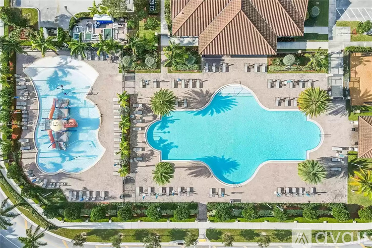 An aerial view of a resort with a large swimming pool and a smaller wave pool.