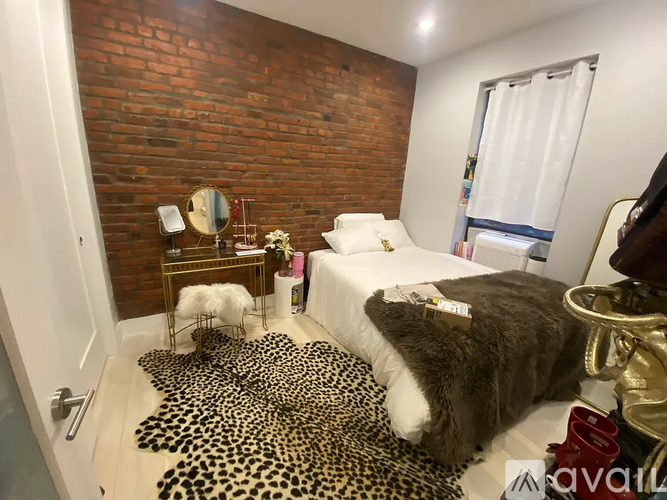 A bedroom with a leopard print rug and a leopard print bedspread.