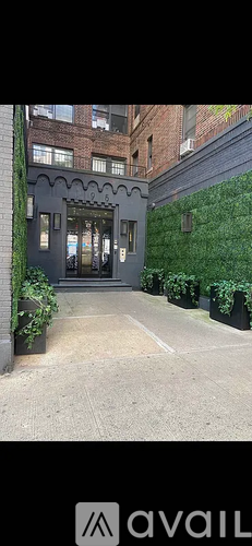 A building entrance with a green wall on the right side.