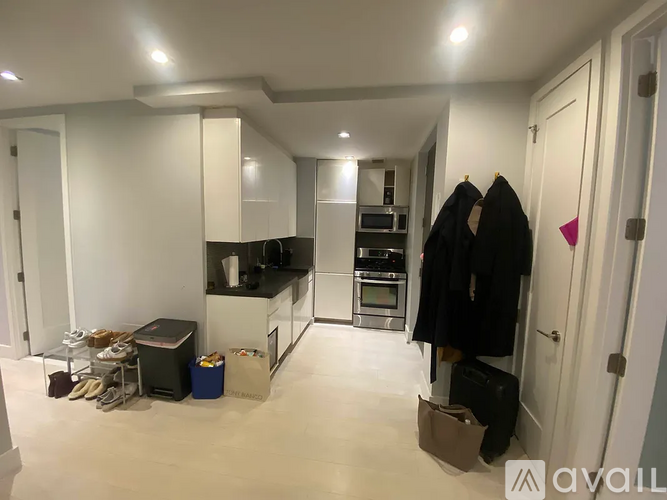 A kitchen with a black counter top and white cabinets.