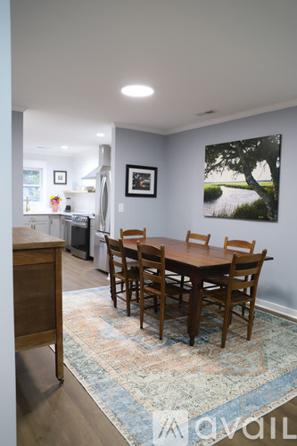 A dining room with a table and chairs.