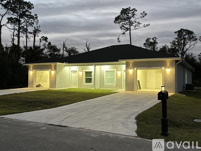 A house with a driveway and a mailbox in front.