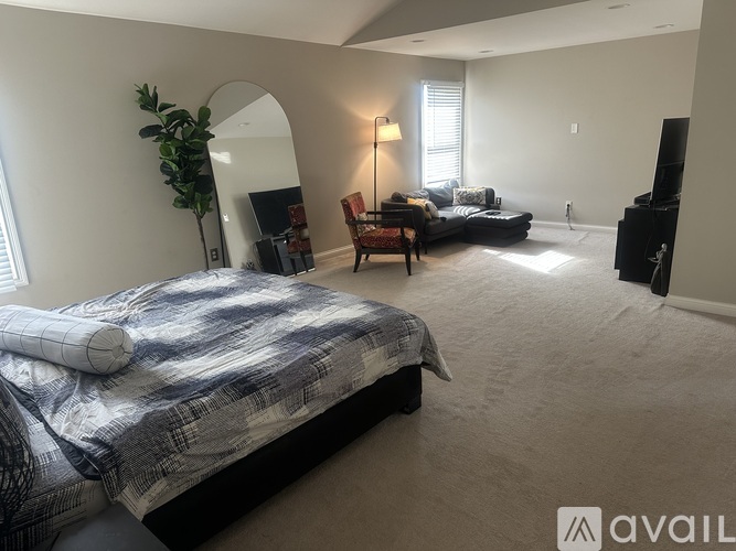 A bedroom with a large bed and a television.