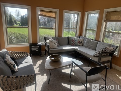 A living room with a grey couch and a coffee table.