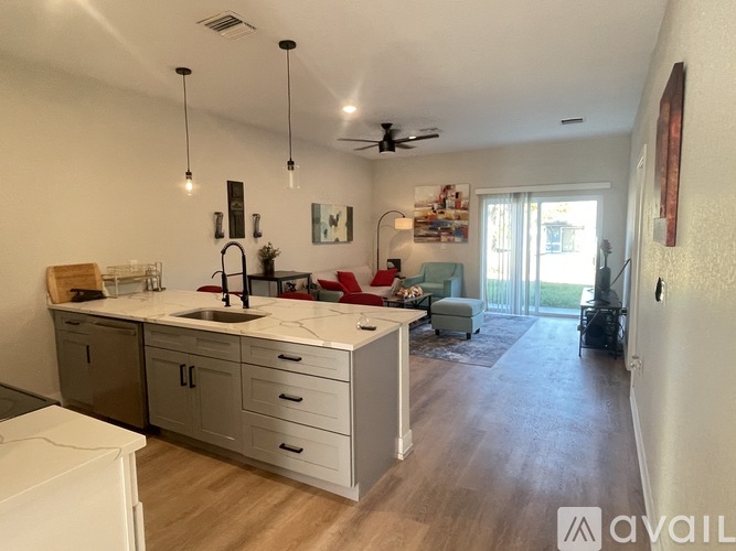 A kitchen with a white dishwasher and a white washing machine.