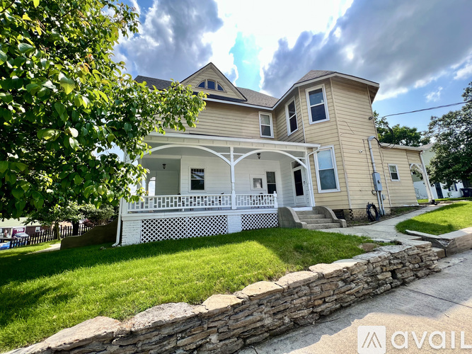 A house with a stone wall in front.