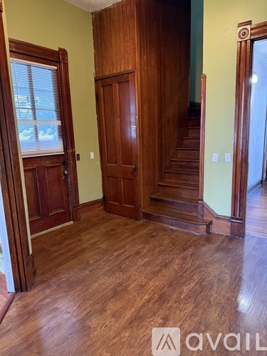 A room with wooden floors and a wooden door.