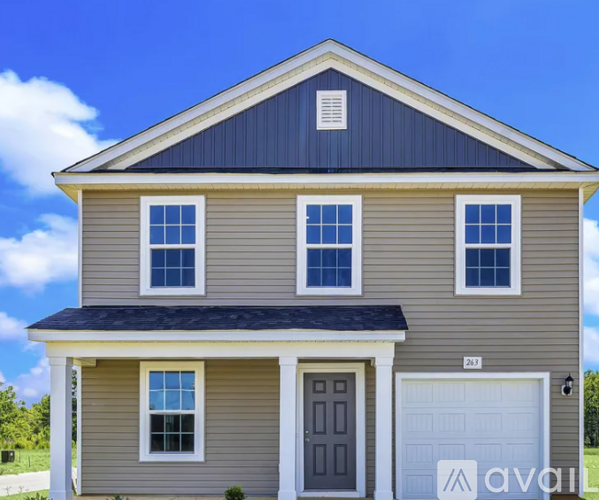 A two-story house with a garage on the right side.